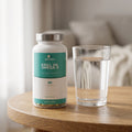 Krill Oil pot on a wooden table with a glass of water