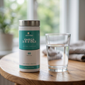 Omega 3-6-9 pot on a wooden table with a glass of water