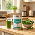 Super Greens tub on a kitchen counter beside a green smoothie