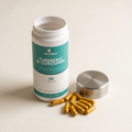 Turmeric & Curcumin golden-yellow capsules beside the open pot